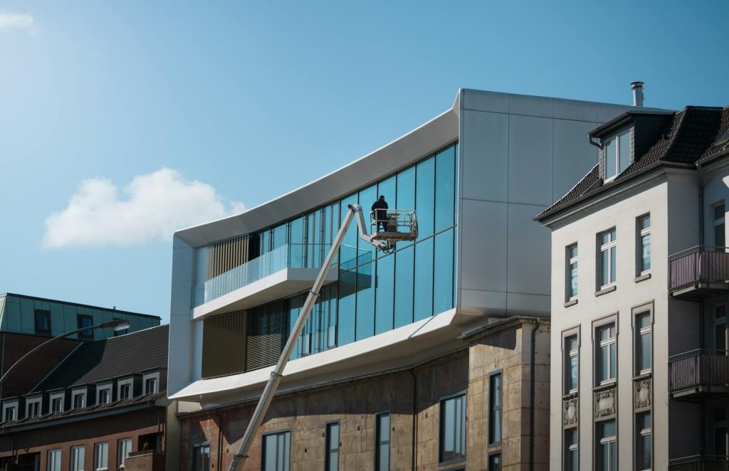 Modern architecture with glass facade in Hamburg, Germany under clear skies.