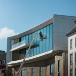 Modern architecture with glass facade in Hamburg, Germany under clear skies.