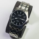 Close-up of a classic Citizen Eco-Drive wristwatch with a stainless steel bracelet.