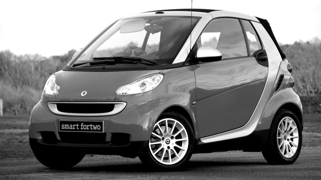 Stylish Smart Fortwo car parked outdoors, showcasing modern design and compact style.